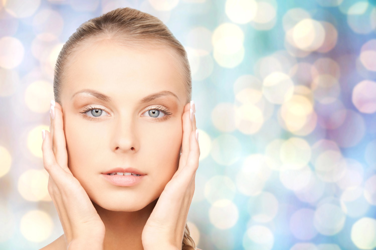Woman framing her face with both hands, highlighting the brow and forehead area commonly assessed for a Botox brow lift.